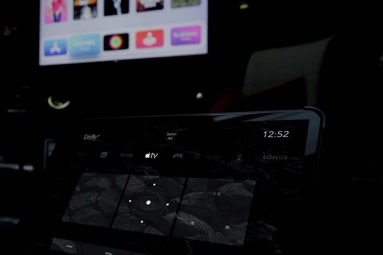 Screens and a control interface in a darkened room.