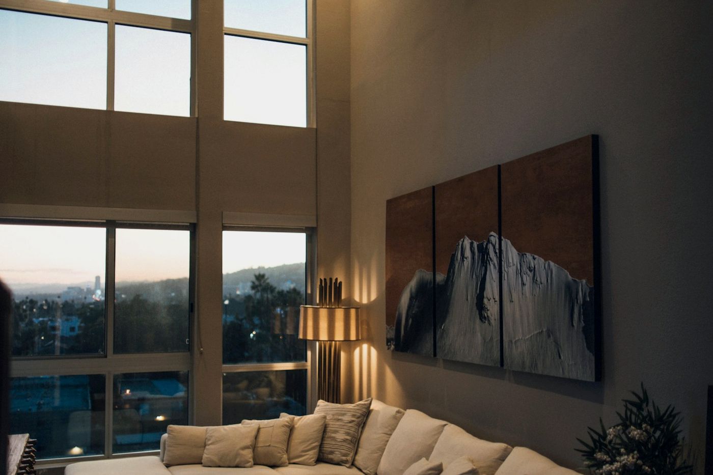 An evening interior with a living space and screen, lit low.